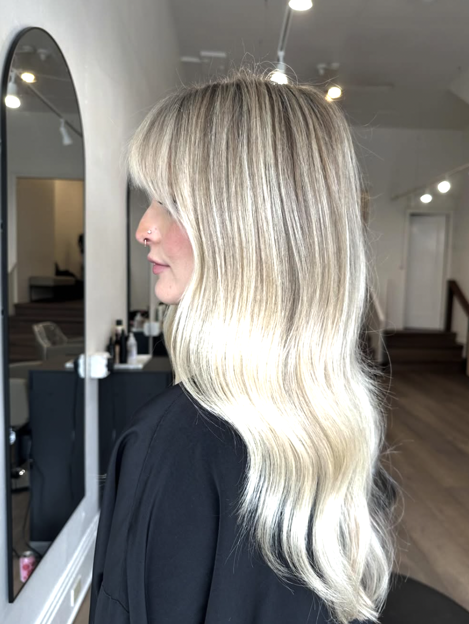 Long luminous platinum blonde hair shown in profile