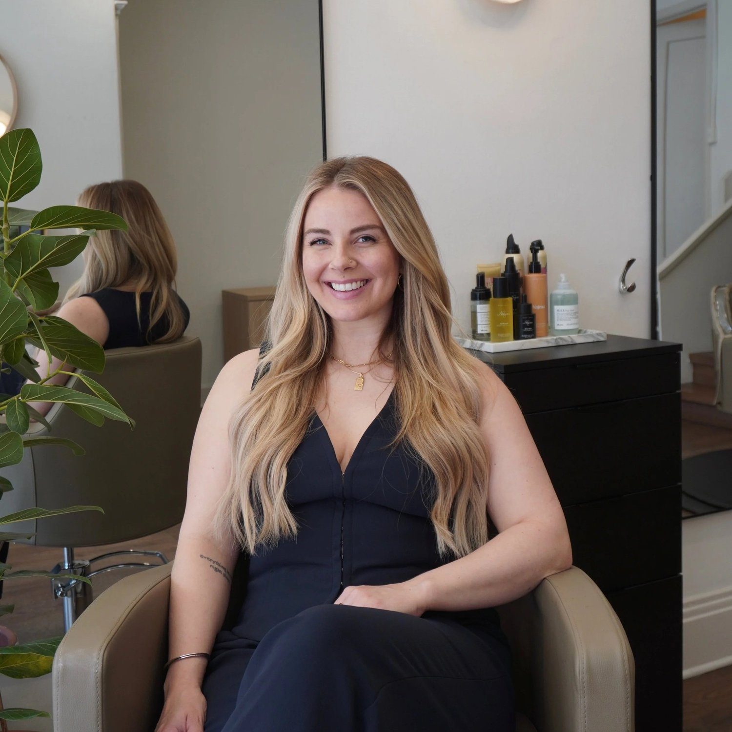 Mara Lundberg, owner of Era Salon, in a styling chair